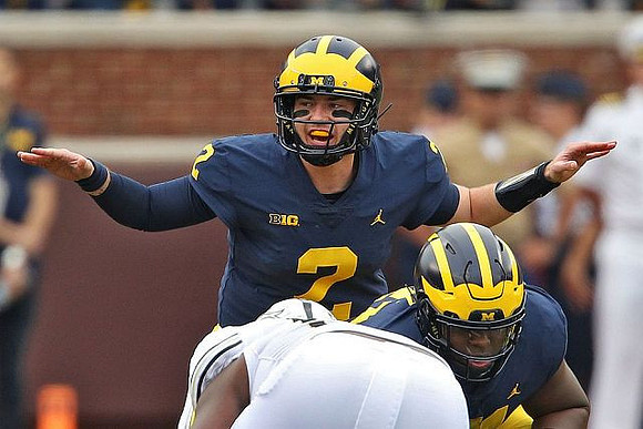 Shea Patterson (2) and Cesar Ruiz (51)