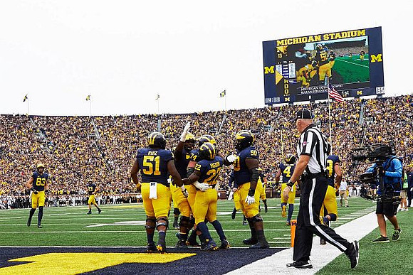 Zach Gentry (83), Cesar Ruiz (51), Ben Bredeson (74), Karan Higdon (22), Michael Onwenu (50), and Nico Collins (4)