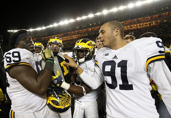 Willie Henry (69), Jabrill Peppers (5), Kenny Allen (91), and The Little Brown Jug
