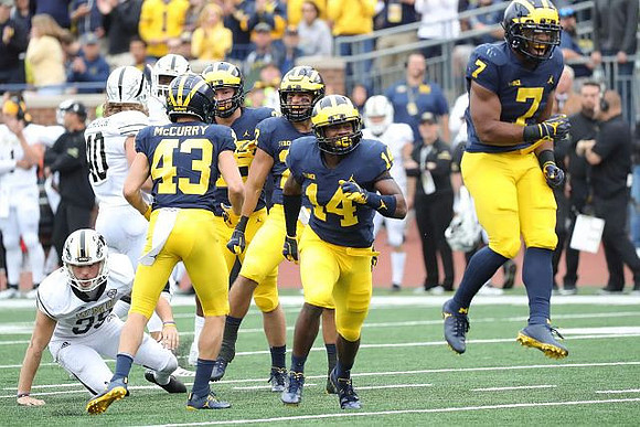 Jake McCurry (43), Josh Metellus (14), and Khaleke Hudson (7)