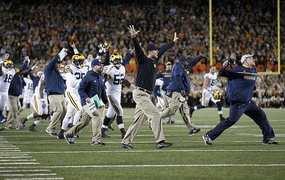 Dymonte Thomas (25), Royce Jenkins-Stone (52), and Jim Harbaugh