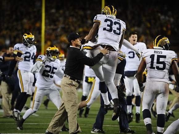 Wayne Lyons (24), Dymonte Thomas (25), Jim Harbaugh, Taco Charlton (33), Wilton Speight (3), and James Ross (15)