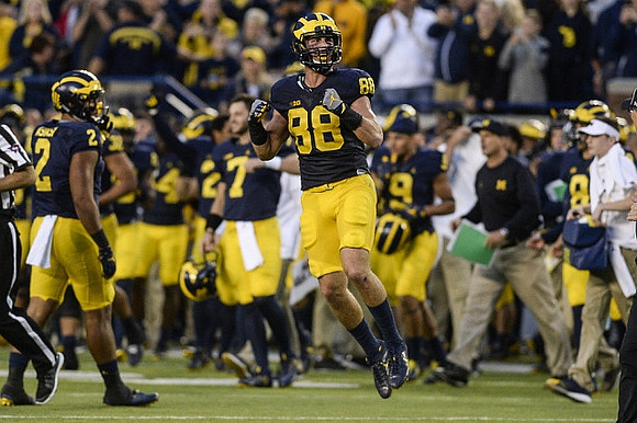 Devin Asiasi (2), Jake Butt (88), and Michigan Team