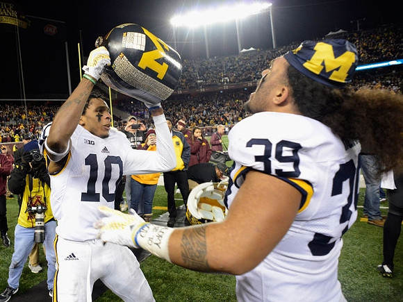 Da'Mario Jones (10), Sione Houma (39), and The Little Brown Jug