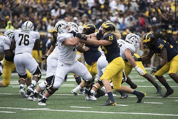 Chase Winovich (15) and Devin Gil (36)
