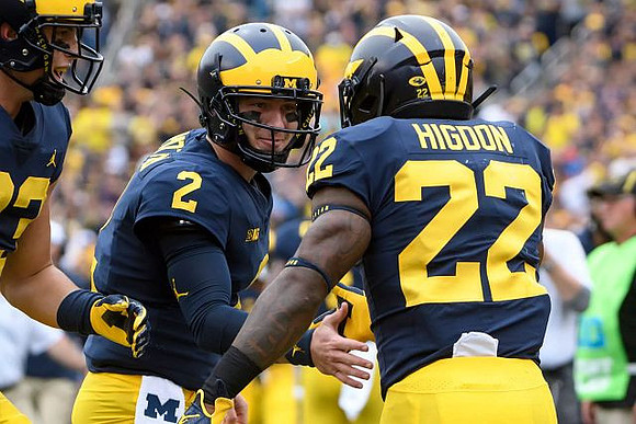 Zach Gentry (83), Shea Patterson (2), and Karan Higdon (22)