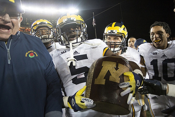 Jon Falk, Maurice Ways (85), Jabrill Peppers (5), Da'Mario Jones (10), and The Little Brown Jug