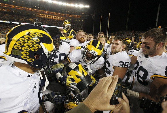 Jabrill Peppers (5), Kyle Kalis (67), Joe Kerridge (36), Jake Butt (88), and The Little Brown Jug