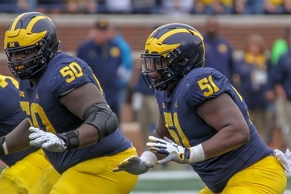 Michael Onwenu (50) and Cesar Ruiz (51)