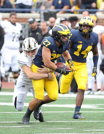 Joe Hewlett (27) and Josh Metellus (14)