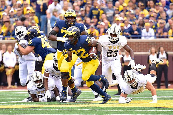Karan Higdon (22), Ben Mason (42), and Juwann Bushell-Beatty (76)