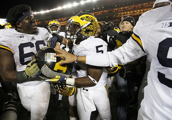 Willie Henry (69), Jabrill Peppers (5), and The Little Brown Jug