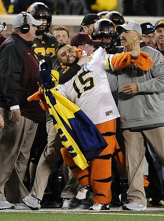 Minnesota Interim Head Coach Tracy Claeys and Fan Running on Field