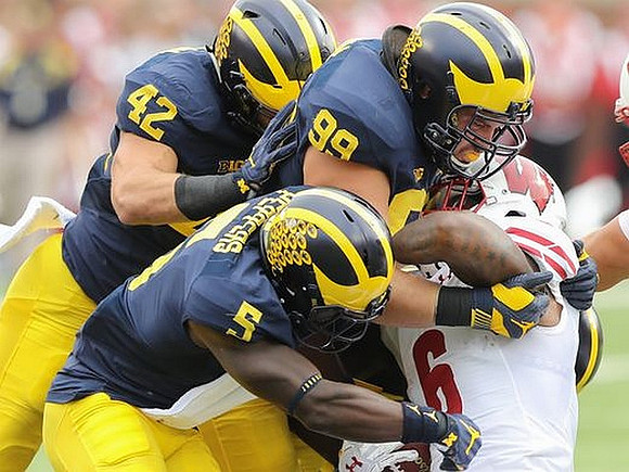 Ben Gedeon (42), Jabrill Peppers (5), and Matthew Godin (99)