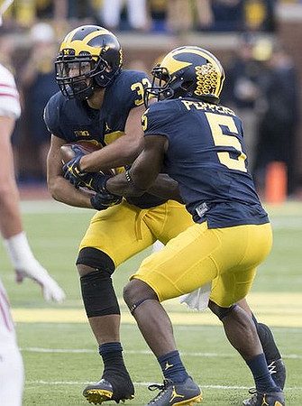 Ty Isaac (32) and Jabrill Peppers (5)