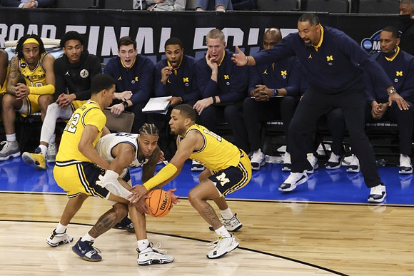 Caleb Houstan (22), DeVante' Jones (12), and Juwan Howard