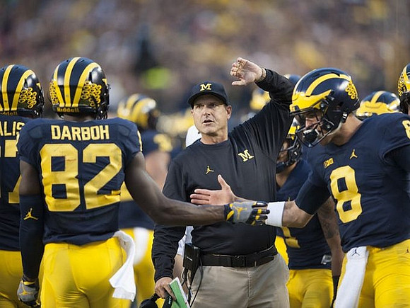 Kyle Kalis (67), Amara Darboh (82), Jim Harbaugh, and John O'Korn (8)