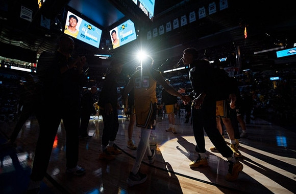 Eli Brooks (55) and Michigan Team