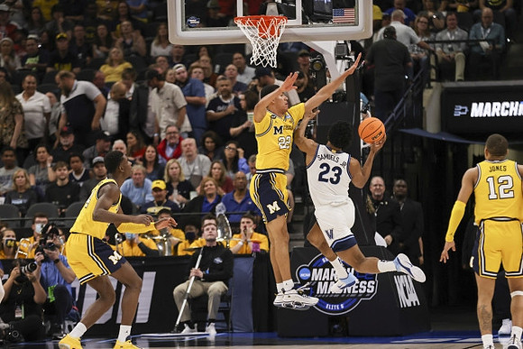 Caleb Houstan (22), Moussa Diabate (14), and DeVante' Jones (12)