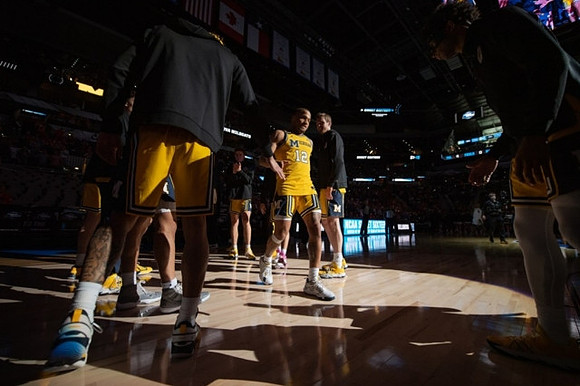 DeVante' Jones (12) and Michigan Team
