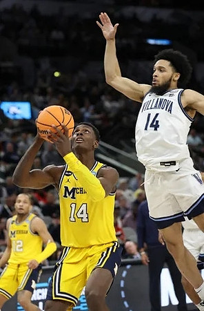 Moussa Diabate (14) and DeVante' Jones (12)