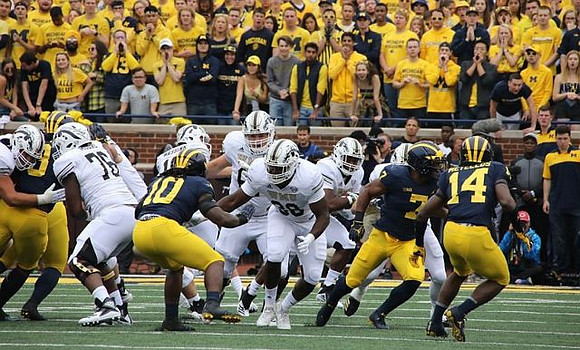 Devin Bush (10), Khaleke Hudson (7), and Josh Metellus (14)