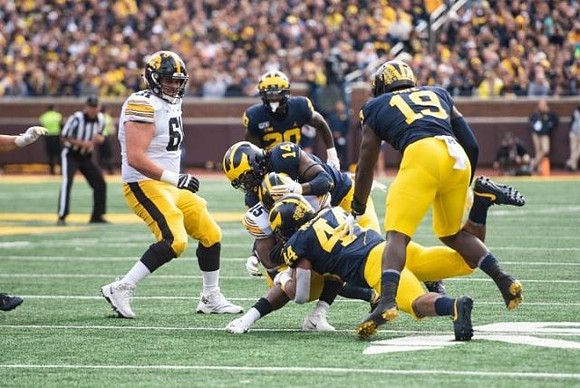 Brad Hawkins (20), Josh Metellus (14), Cameron McGrone (44), and Kwity Paye (19)
