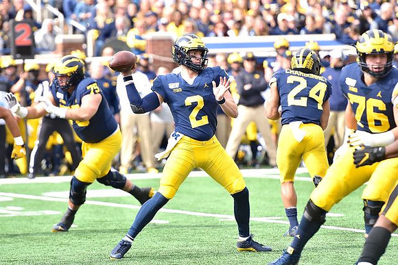 Jon Runyan Jr. (75), Shea Patterson (2), Zach Charbonnet (24), and Ryan Hayes (76)