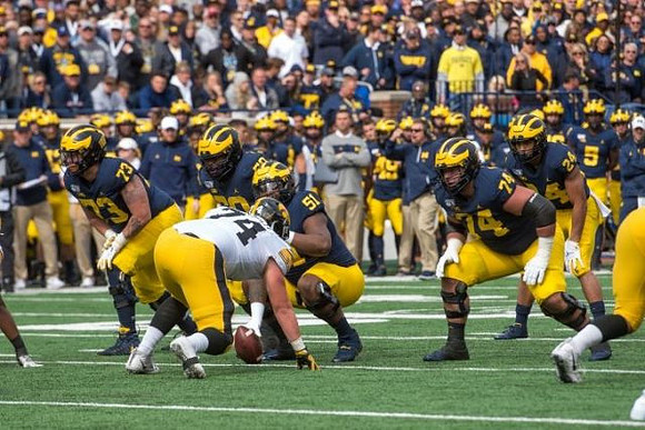 Jalen Mayfield (73), Michael Onwenu (50), Cesar Ruiz (51), Ben Bredeson (74), and Zach Charbonnet (24)
