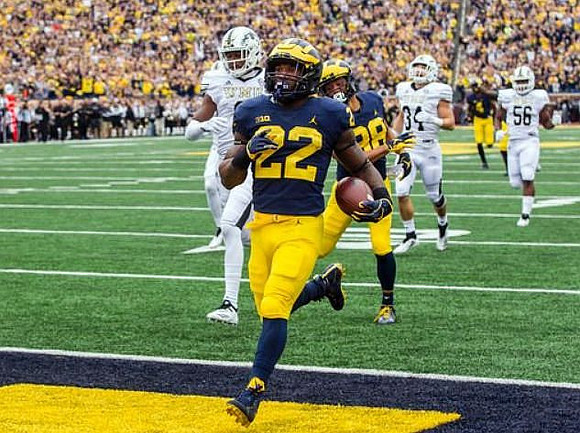 Karan Higdon (22) and Grant Perry (88)