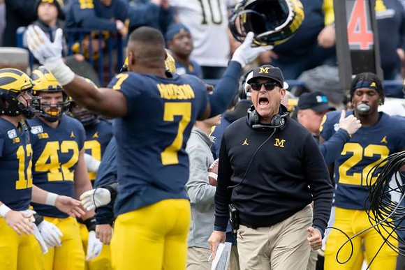 Will Hart (17), Ben Mason (42), Khaleke Hudson (7), Jim Harbaugh, and Gemon Green (22)