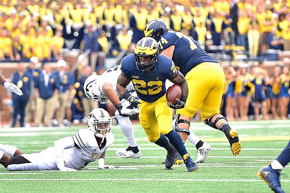 Karan Higdon (22) and Ben Bredeson (74)
