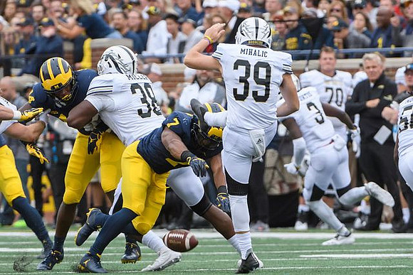 Josh Metellus (14) and Khaleke Hudson (7)