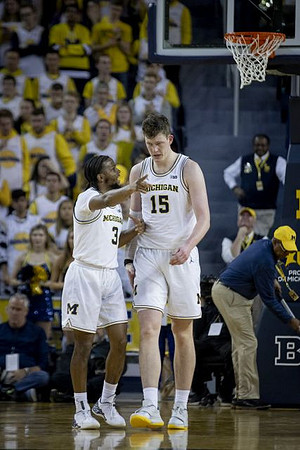 Zavier Simpson (3) and Jon Teske (15)