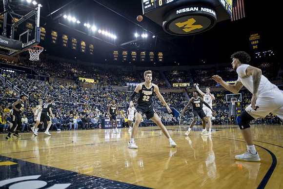 Zavier Simpson (3), Jon Teske (15), and Brandon Johns Jr. (23)
