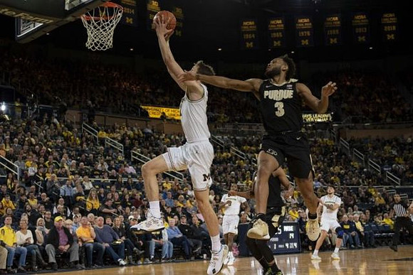 Franz Wagner (21), Zavier Simpson (3), and Brandon Johns Jr. (23)