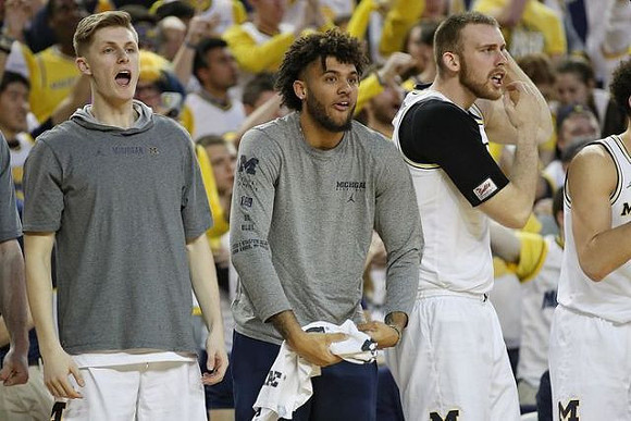 Cole Bajema (22), Isaiah Livers (2), and Austin Davis (51)