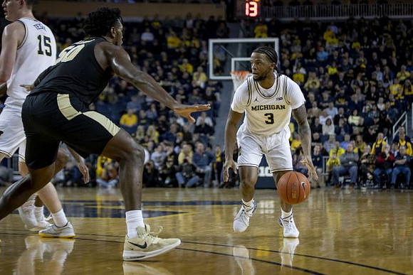 Jon Teske (15) and Zavier Simpson (3)