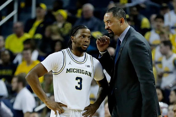 Zavier Simpson (3) and Juwan Howard