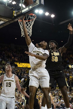 Jon Teske (15) and Zavier Simpson (3)