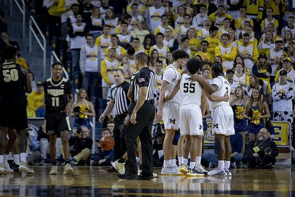Brandon Johns Jr. (23), Eli Brooks (55), and Zavier Simpson (3)