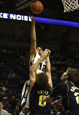 Zack Novak (0) and Evan Smotrycz (23)