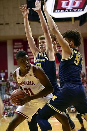 Moritz Wagner (13) and D.J. Wilson (5)