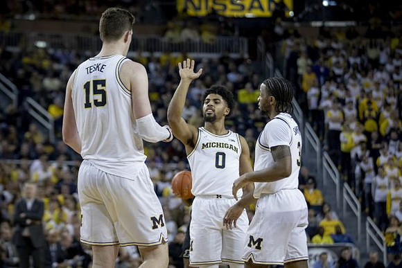 Jon Teske (15), David DeJulius (0), and Zavier Simpson (3)