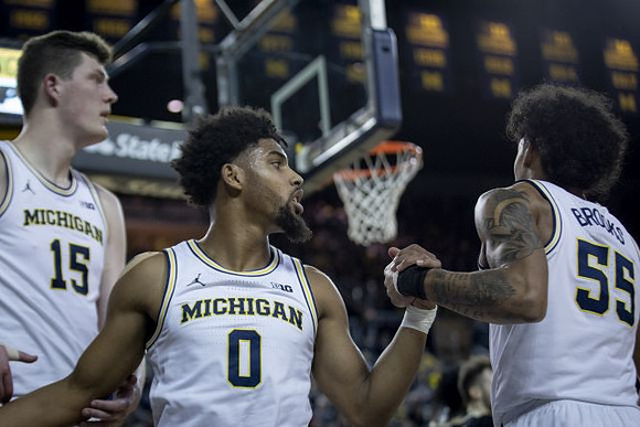 Jon Teske (15), David DeJulius (0), and Eli Brooks (55)