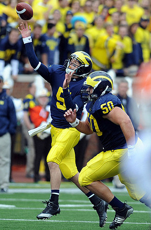 Tate Forcier (5) and David Molk (50)