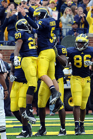 Michael Shaw (20), Tate Forcier (5), Martell Webb (80), and Kevin Koger (86)