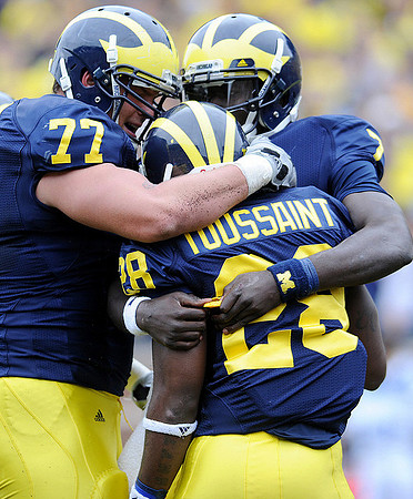 Taylor Lewan (77), Fitzgerald Toussaint (28), and Devin Gardner (7)