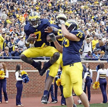 Devin Gardner (7), Brandon Moore (88), and Michael Schofield (75)