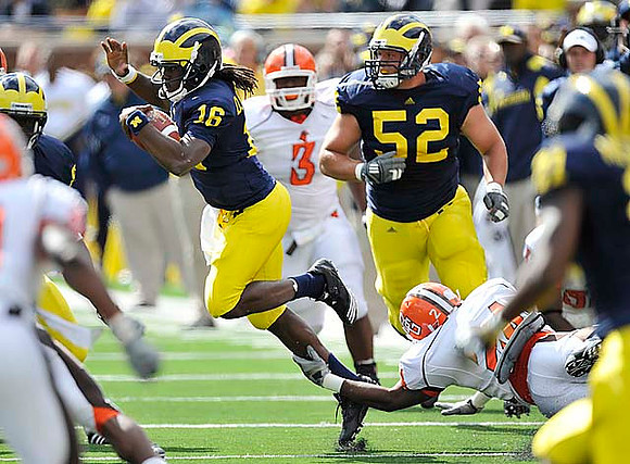 Denard Robinson (16) and Stephen Schilling (52)